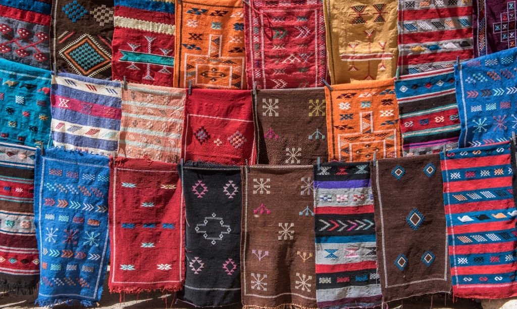 Lots of colorful rugs for sale in souk of medina of old city of Marrakesh, Morocco